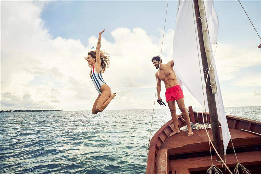 Couple Jumping Off Boat